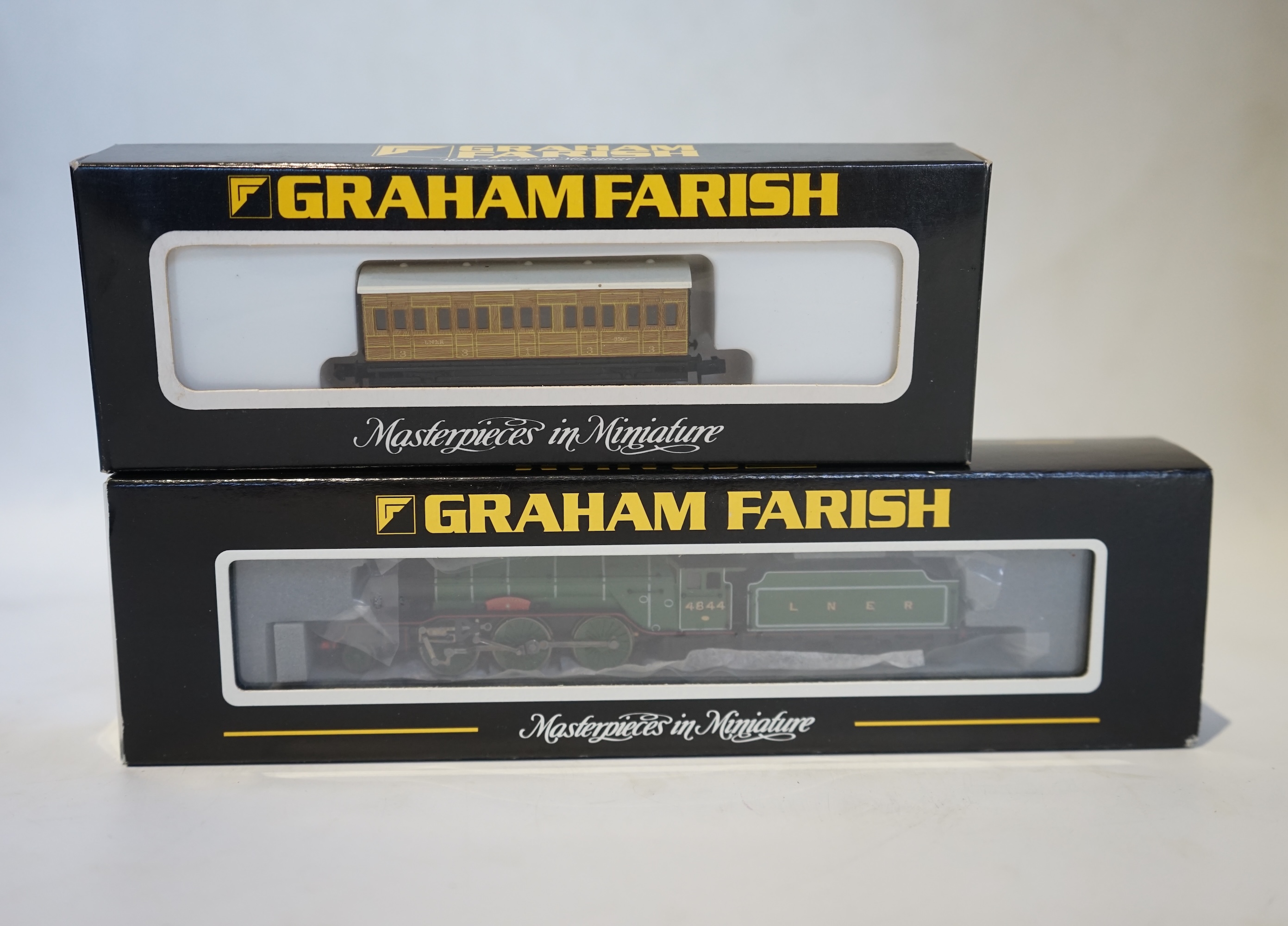 Twenty boxed Graham Farish N gauge railway; an LNER Class V2 2-6-2 tender locomotive, Coldstreamer, (372-602), together with nineteen LNER teak 4-wheel coaches. Condition - good.